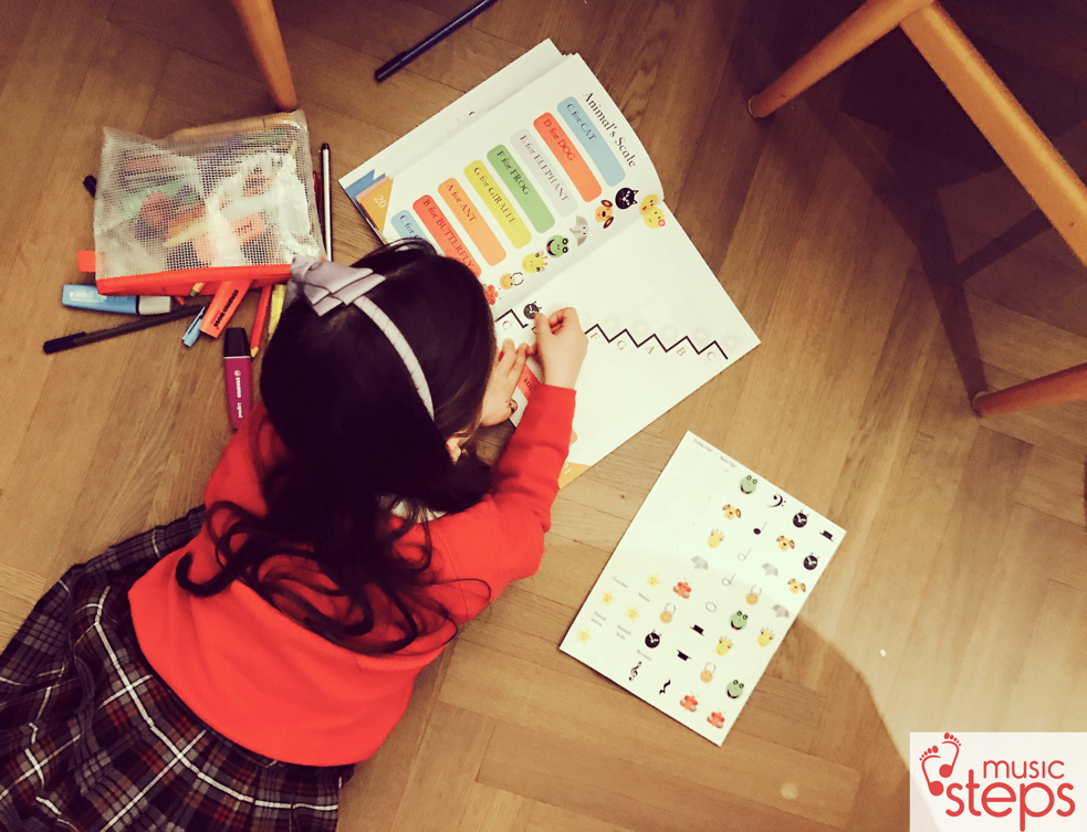 Child exploring music theory activities